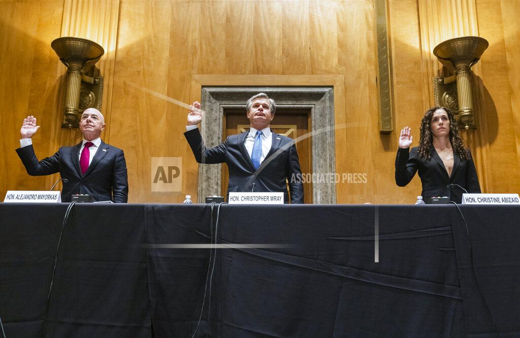 Jim Lo Scalzo Secretary of Homeland Security Alejandro Mayorkas, left, FBI Director Christopher Wray, center, and Director of the National Counterterrorism Center Christine Abizaid, are sworn-in prior to testifying before a Senate Homeland Security and Governmental Affairs Committee hearing to discuss security threats 20 years after the 9/11 terrorist attacks, Tuesday, Sept. 21, 2021 on Capitol Hill in Washington. (Jim Lo Scalzo/Pool via AP)