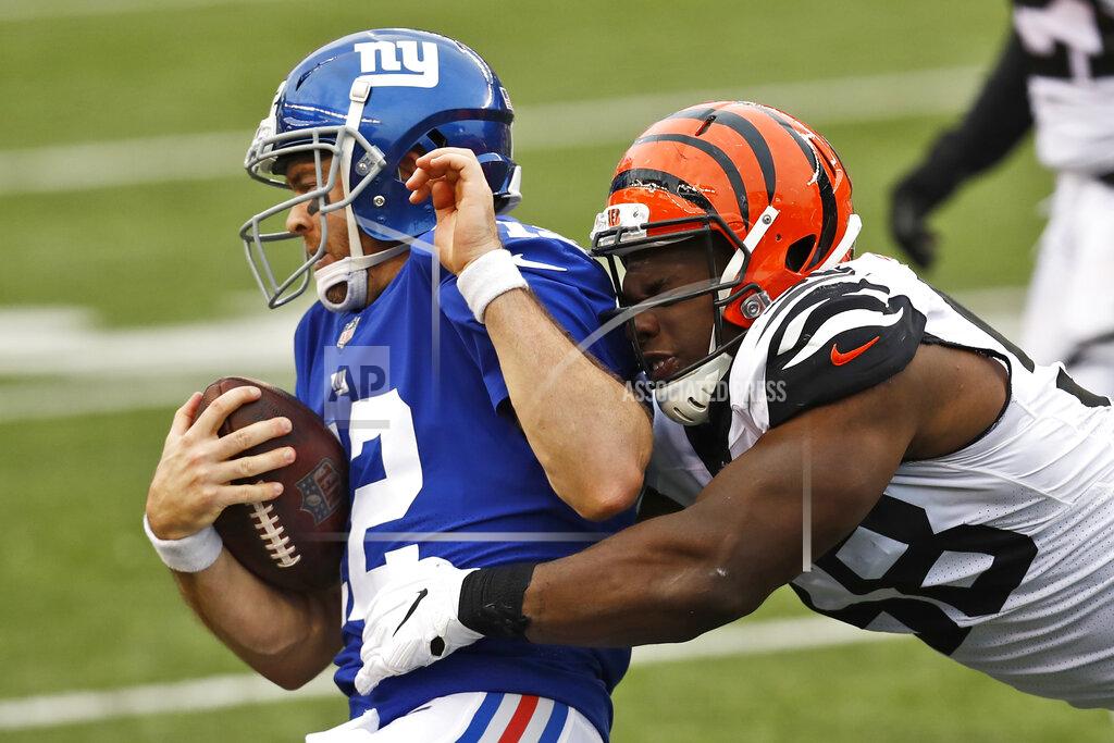 Aaron Doster New York Giants quarterback Colt McCoy (12) is tackled by Cincinnati Bengals defensive end Carl Lawson (58) during the second half of NFL football game, Sunday, Nov. 29, 2020, in Cincinnati. (AP Photo/Aaron Doster)