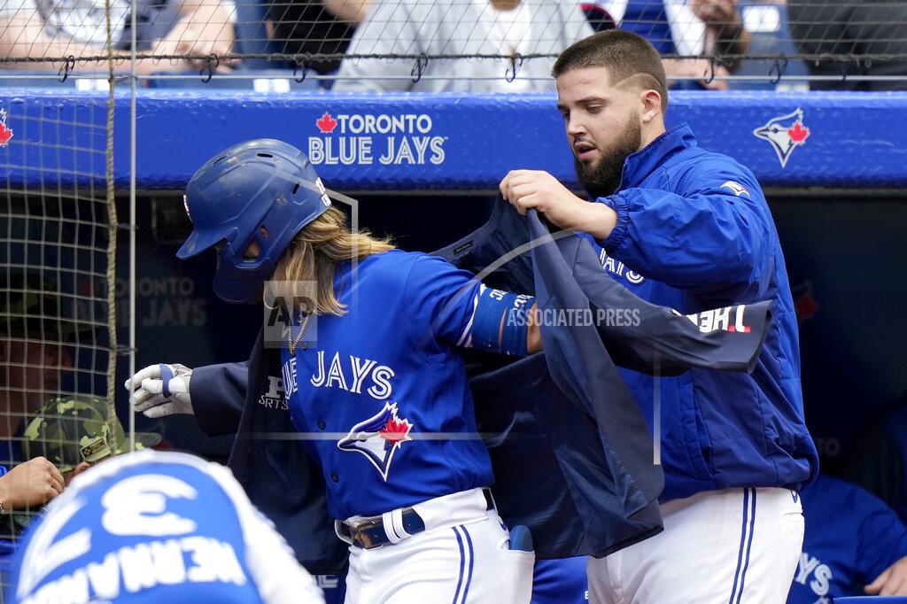 Frank Gunn Toronto Blue Jays starting pitcher Alek Manoah (6) puts the home run jacket on teammate Bo Bichette after his solo homer in the fourth inning of a baseball game against the Cincinnati Reds in Toronto, Saturday, May 21, 2022. (Frank Gunn/The Canadian Press via AP)