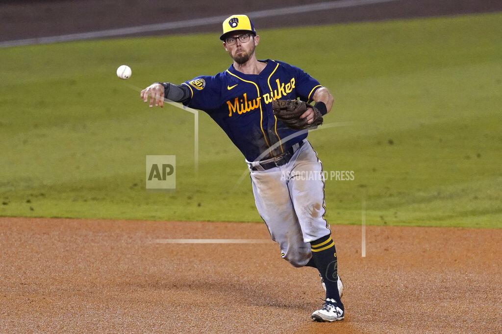 Ashley Landis FILE - In this Sept. 30, 2020, file photo, Milwaukee Brewers third baseman Eric Sogard throws to first base during Game 1 of a National League wild-card baseball series in Los Angeles. The Brewers have declined 2021 options on infielders Jedd Gyorko and Eric Sogard as well as outfielder Ben Gamel. (AP Photo/Ashley Landis, File)