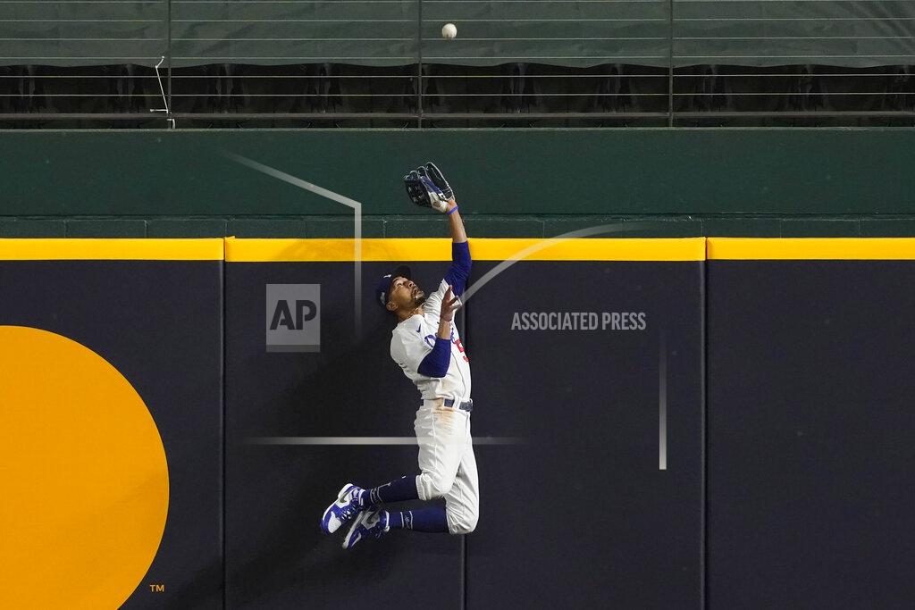 Tony Gutierrez Los Angeles Dodgers right fielder Mookie Betts robs Atlanta Braves' Freddie Freeman of a home run during the fifth inning in Game 7 of a baseball National League Championship Series Sunday, Oct. 18, 2020, in Arlington, Texas. (AP Photo/Tony Gutierrez)