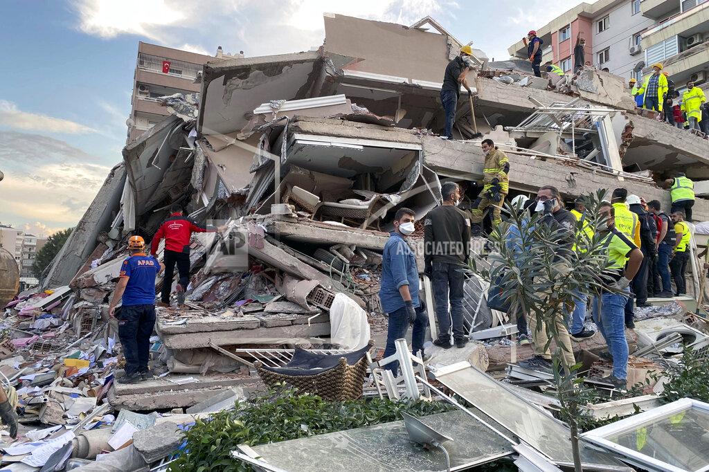 Ismail Gokmen Rescue workers try to save people trapped in the debris of a collapsed building, in Izmir, Turkey, Friday, Oct. 30, 2020. A strong earthquake struck Friday in the Aegean Sea between the Turkish coast and the Greek island of Samos, killing several people and injuring hundreds amid collapsed buildings and flooding, officials said.(AP Photo/Ismail Gokmen)