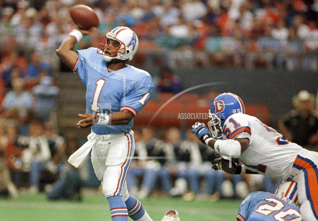 Anonymous FILE - In this Oct. 7, 1991, file photo, Houston Oilers quarterback Warren Moon (1) throws a pass against the Denver Broncos during an NFL football game in Houston. Moon went undrafted after a stellar college career at Washington and was forced to play in Canada where he won two Grey Cup MVP awards in the CFL title game and was the most outstanding player in the league in 1983. He finally got his shot in the NFL the following year with Houston and went on to throw for 49,325 yards in a Hall of Fame career that would have been even more prolific if he hadn't spent his first six seasons in Canada. (AP Photo, File)