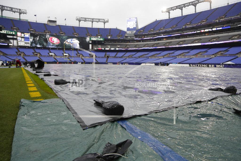 Julio Cortez A tarp covers the field during rain showers in preparation for an NFL football game between the Baltimore Ravens and the San Francisco 49ers, Sunday, Dec. 1, 2019, in Baltimore, Md. (AP Photo/Julio Cortez)