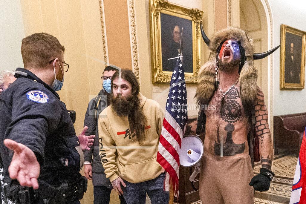 Manuel Balce Ceneta FILE - In this Jan. 6, 2021, file photo, is Jacob Chansley, right with fur hat, during the Capitol riot in Washington. Chansley pleaded guilty on Friday, Sept. 3, 2021, to a felony obstruction charge. He carried a flagpole topped with a spear into the insurrection, yelled into a bullhorn as officers tried to control the crowd, posed for photos on the Senate dais and wrote a note to then-Vice President Mike Pence that prosecutors have said was threatening. (AP Photo/Manuel Balce Ceneta, File)