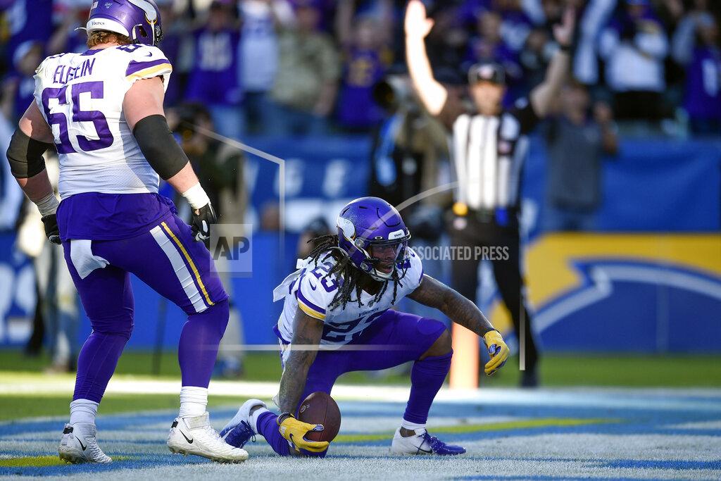 Kelvin Kuo Minnesota Vikings running back Mike Boone, right, reacts with teammates after scoring a touchdown during the second half of an NFL football game against the Los Angeles Chargers, Sunday, Dec. 15, 2019, in Carson, Calif. (AP Photo/Kelvin Kuo)