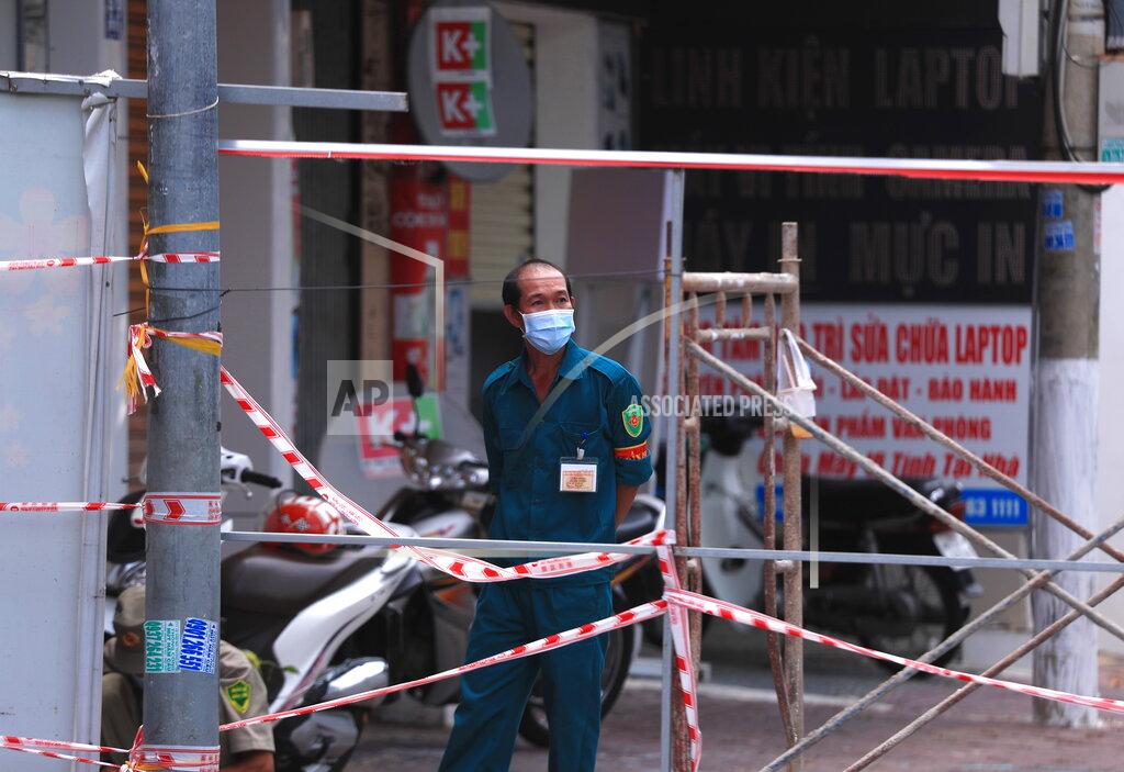 Hau Dinh A security officer guards a road block in Vung Tau, Vietnam, Monday, Sept. 13, 2021. The roadblocks and barricades make the streets of this southern Vietnamese city look like they did during the war that ended almost 50 years ago. But this time, the battle is being fought against the rampaging coronavirus.(AP Photo/Hau Dinh)