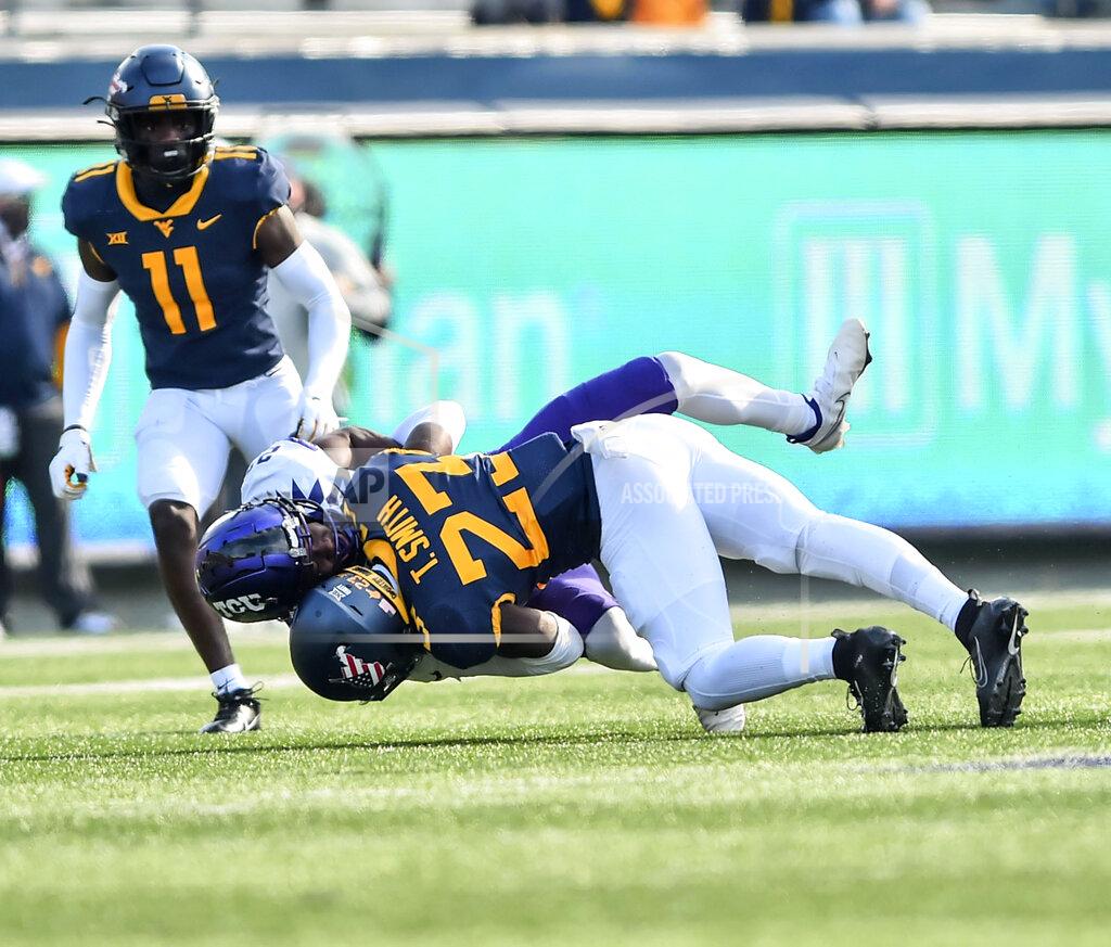 William Wotring West Virginia safety Tykee Smith (23) makes a tackle against TCU during the first half of an NCAA college football game on Saturday, Nov. 14, 2020, in Morgantown, W.Va. (William Wotring/The Dominion-Post via AP)