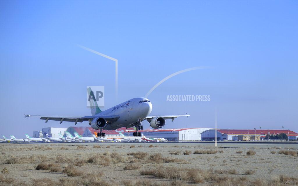 Saeed Kaari In this photo released by Imam Khomeini Airport City, an Iranian Mahan Air plane carrying Russian-made Sputnik V coronavirus vaccines lands at the Tehran's Imam Khomeini International Airport, Thursday, Feb. 4, 2021. Iran on Thursday received its first batch of foreign-made coronavirus vaccines as the country struggles to stem the worst outbreak of the pandemic in the Middle East. (Saeed Kaari/IKAC via AP)