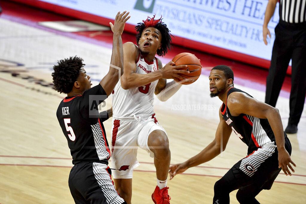Michael Woods Arkansas guard Desi Sills (3) tries to drive past Georgia defenders Justin Kier (5) and P.J. Horne (24) during the second half of an NCAA college basketball game Saturday, Jan. 9, 2021, in Fayetteville, Ark. (AP Photo/Michael Woods)
