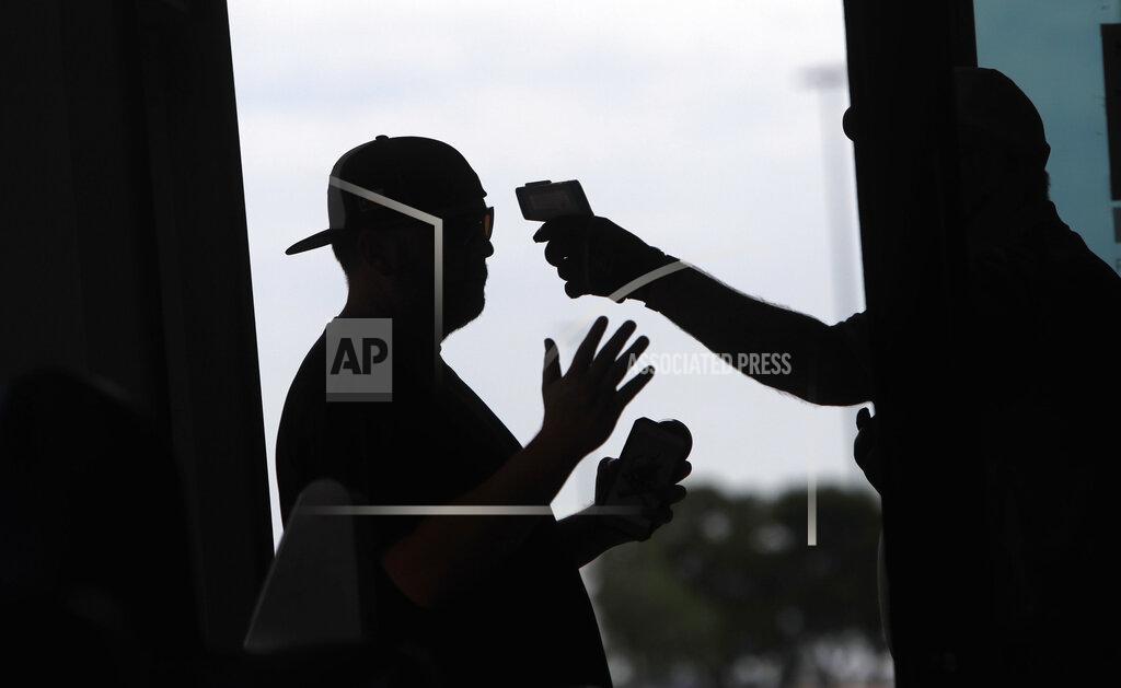 Lm Otero Amid concerns of the spread of the virus that causes COVID-19, a baseball fan has his temperature checked by a security guard before being allowed to tour Globe Life Field, home of the Texas Rangers baseball team in Arlington, Texas, Monday, June 1, 2020. (AP Photo/LM Otero, File)