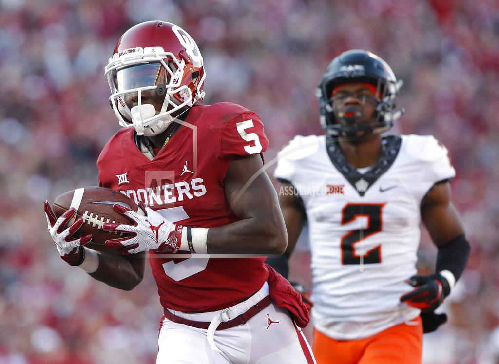 Alonzo Adams Oklahoma wide receiver Marquise Brown (5) runs in for a touchdown ahead of Oklahoma State cornerback Tanner McCalister (2) in the second quarter of an NCAA college football game in Norman, Okla., Saturday, Nov. 10, 2018. (AP Photo/Alonzo Adams)