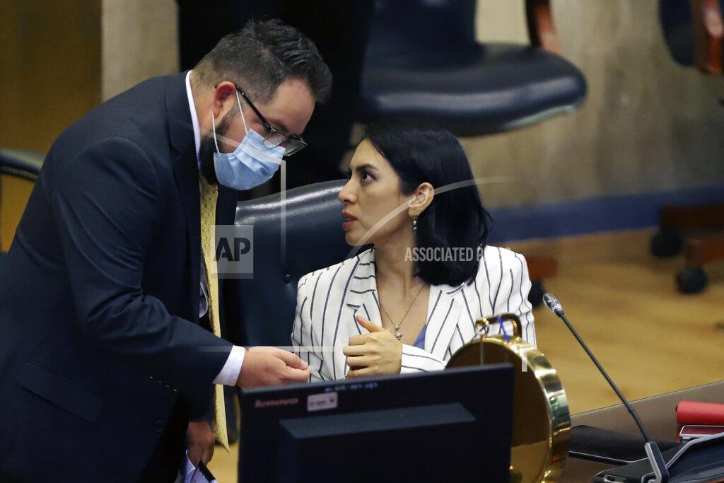 Salvador Melendez Suecy Callejas, Vice President of the Congress, center, talks to an unidentified man during the first session in San Salvador, El Salvador, Saturday, May 1, 2021. For the first time in three decades the traditional conservative and leftist parties have been sidelined by a resounding electoral defeat, clearing the way for President Nayib Bukele's party to help him advance his agenda. (AP Photo/Salvador Melendez)