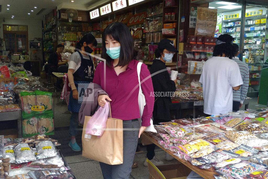 Chiang Ying-Ying People wearing face masks to help curb the spread of the coronavirus shop at a market in Taipei, Taiwan, Monday, Oct. 19, 2020. (AP Photo/Chiang Ying-ying)