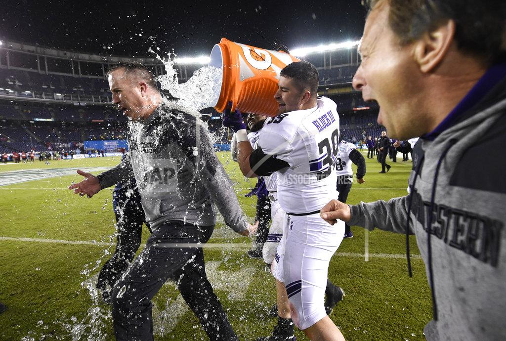 Denis Poroy Northwestern offensive lineman Trey Klock (39) douses head coach Pat Fitzgerald as time runs out during the Holiday Bowl NCAA college football game against Utah, Monday, Dec. 31, 2018, in San Diego. (AP Photo/Denis Poroy)