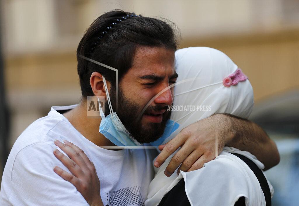 Hussein Malla Relatives of Ibrahim Harb, 35, who was critically injured in the massive explosion at Beirut's port last year and who died on Monday nearly 14 months after the blast, mourn during his funeral procession in Beirut, Lebanon, Tuesday, Sept. 28, 2021. On Aug. 4, 2020, hundreds of tons of ammonium nitrate, a highly explosive material used in fertilizers, ignited after a massive fire at the port. The death brings to at least 215 the number of people who have been killed by the blast, according to official records. (AP Photo/Hussein Malla)