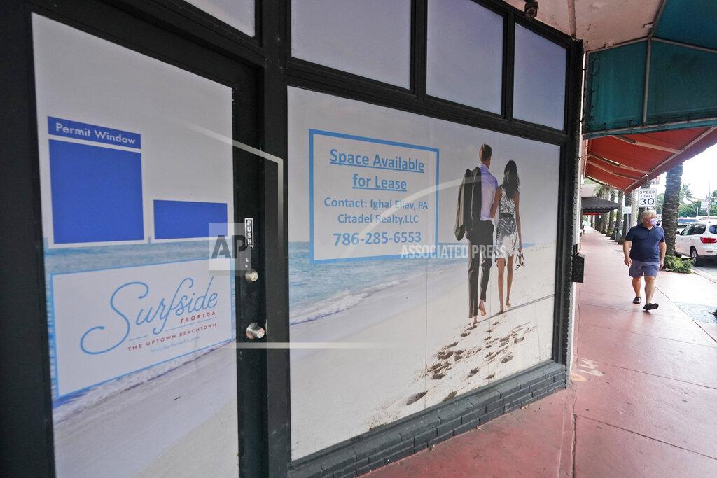 A pedestrian walks past an empty business available for lease, Monday, Oct. 12, 2020, in downtown Surfside, Fla. The pandemic and recession are squeezing big apartment building owners, with a surge in vacancies leading to a decline in rent growth for the first time in years. The U.S. vacancy rate for apartments rose to 5% in the third quarter, the highest level in eight years, according to Moody’s Analytics REIS. (AP Photo/Wilfredo Lee)