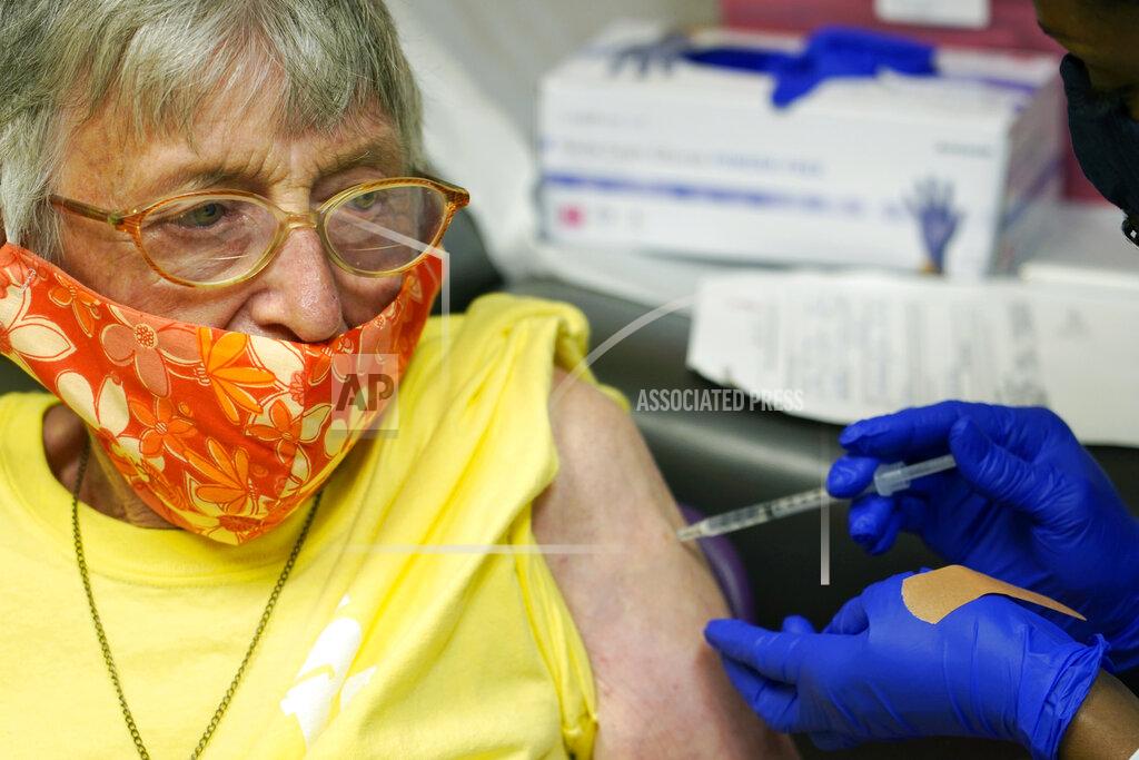 Rogelio V. Solis Linda Busby, 74, stiffens up as she receives the Johnson & Johnson COVID-19 vaccine at the Aaron E. Henry Community Health Service Center, Wednesday, April 7, 2021, in Clarksdale, Miss. Busby joined a group of seniors from the Rev. S.L.A. Jones Activity Center for the Elderly that were given a ride to the health center for their vaccinations. The Mississippi Department of Human Services is in the initial stages of teaming up with community senior services statewide to help older residents get vaccinated. (AP Photo/Rogelio V. Solis)