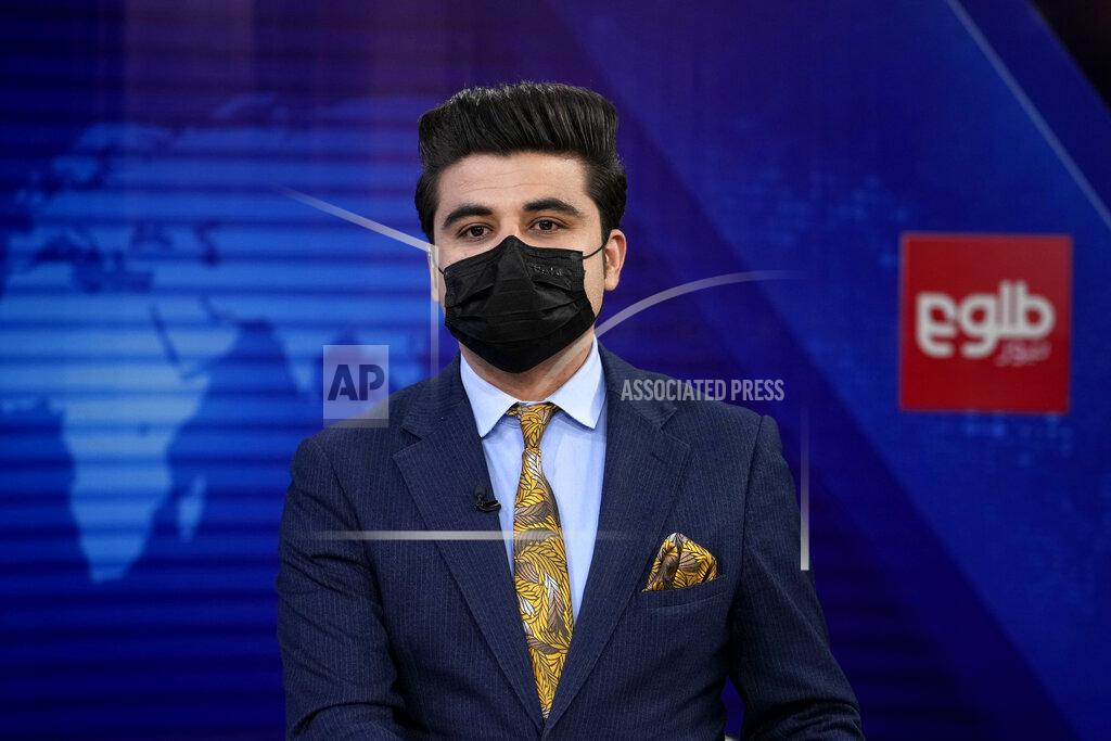 Ebrahim Noroozi TV anchor Nesar Nabil wears a face mask to protest the Taliban's new order that female presenters cover their faces, as he reads the news on TOLOnews, in Kabul, Afghanistan, Sunday, May 22, 2022. Afghanistan's Taliban rulers have begun enforcing an order requiring all female TV news anchors in the country to cover their faces while on-air. The move Sunday is part of a hard-line shift drawing condemnation from rights activists. (AP Photo/Ebrahim Noroozi)