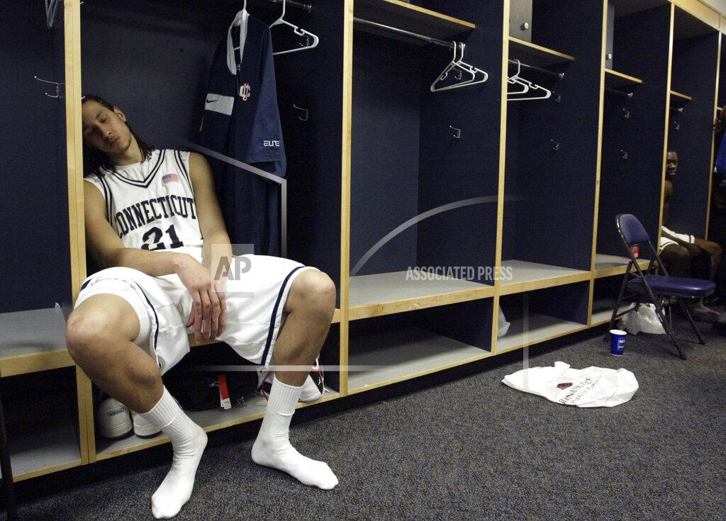 Preston Keres FILE - In this March 26, 2006, file photo, Connecticut's Josh Boone sits in the locker room after his team's 86-84 overtime loss to George Mason in the NCAA basketball tournament regional championship game in Washington. (Preston Keres/The Washington Post via AP, File)