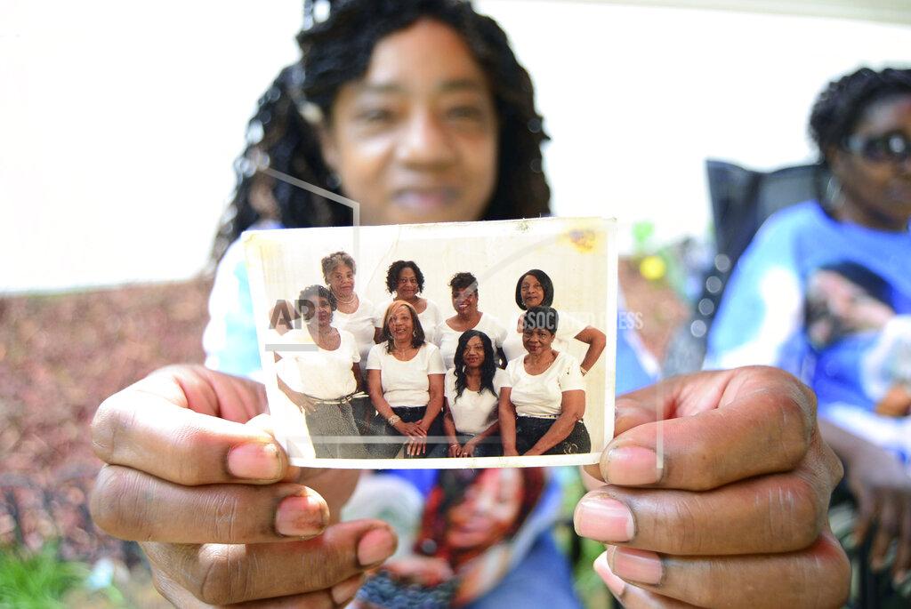 Emily Enfinger Ella Chism holds a photo of her sisters. Sandra Lockett Huckleberry is seen in the back row on the right end. Huckleberry, 56, was found dead inside her Fair Avenue mobile home in Centreville after church services one Sunday in October 2014; she had been stabbed several times. The life of this kind-spirited woman ended violently, leaving only questions that would torment her family ever since: Who killed her and why? (Emily Enfinger/The Tuscaloosa News via AP)