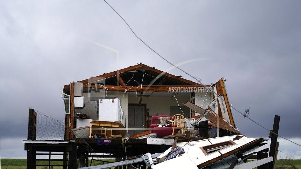 Gerald Herbert Storm clouds from Tropical Storm Nicholas are seen behind a home that was destroyed by Hurricane Ida, in Pointe-aux-Chenes, La., Tuesday, Sept. 14, 2021. (AP Photo/Gerald Herbert) 985-850-1149