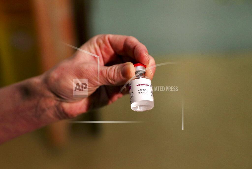 Steve Parsons Chief nurse nurse Sam Foster holds a vial of the Oxford University/AstraZeneca COVID-19 vaccine, at the Churchill Hospital in Oxford, England, Monday, Jan. 4, 2021. England’s National Health Service says a retired maintenance manager has received the first injection of the new vaccine developed by between Oxford University and drug giant AstraZeneca. Dialysis patient Brian Pinker became the very first person to be vaccinated by the chief nurse at Oxford University Hospital. (Steve Parsons/Pool Photo via AP)