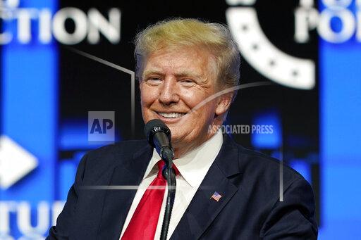 FILE - In this July 24, 2021, file photo, former President Donald Trump smiles as he pauses while speaking to supporters at a Turning Point Action gathering in Phoenix. Trump's social media company will be getting tens of millions in special bonus shares in a new publicly traded entity if it performs well, handing the ex-president possibly billions of dollars in paper wealth based on current stock prices, according to a prospectus filed with security regulators on Tuesday, Oct. 26, 2021. (AP Photo/Ross D. Franklin, File)
