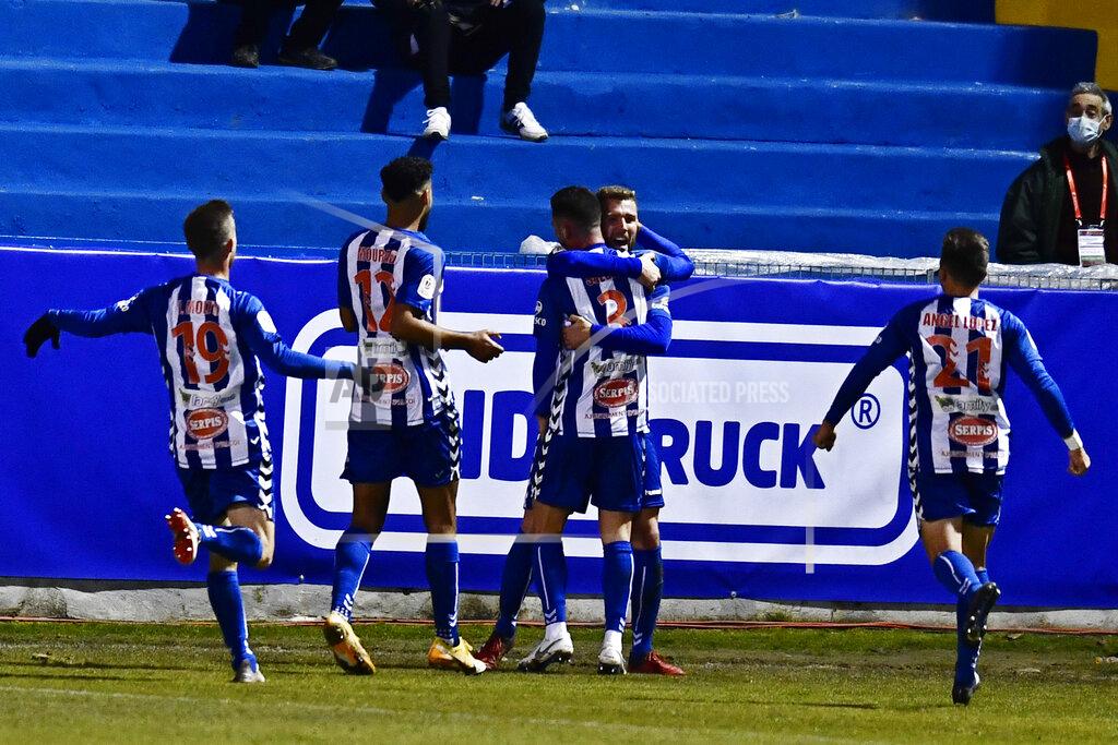 Jose Breton Alcoyano's Jose Solbes, centre celebrates with team mates after scoring the equaliser, his side's first goal during a Spanish Copa del Rey round of 32 soccer match between Alcoyano and Real Madrid at the El Collao stadium in Alcoy, Spain, Wednesday Jan. 20, 2021. (AP Photo/Jose Breton)