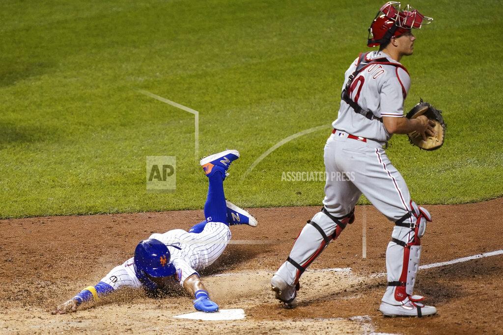 John Minchillo New York Mets' Andres Gimenez scores on a double by Robinson Chirinos off Philadelphia Phillies relief pitcher Ranger Suarez during the sixth inning of a baseball game, Saturday, Sept. 5, 2020, in New York. (AP Photo/John Minchillo)