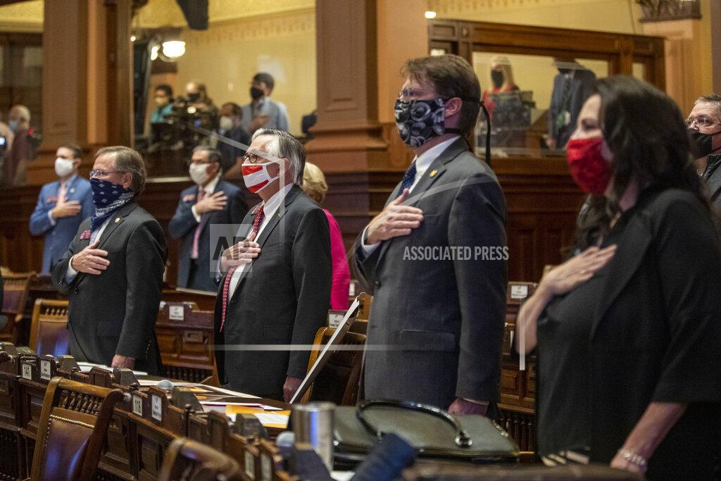 Alyssa Pointer Members of the Georgia House of Representatives stand for the pledge of allegiance during the first day of the 2021 legislative session at the Georgia State Capitol building in Atlanta, Monday, Jan. 11, 2021. (Alyssa Pointer/Atlanta Journal-Constitution via AP)