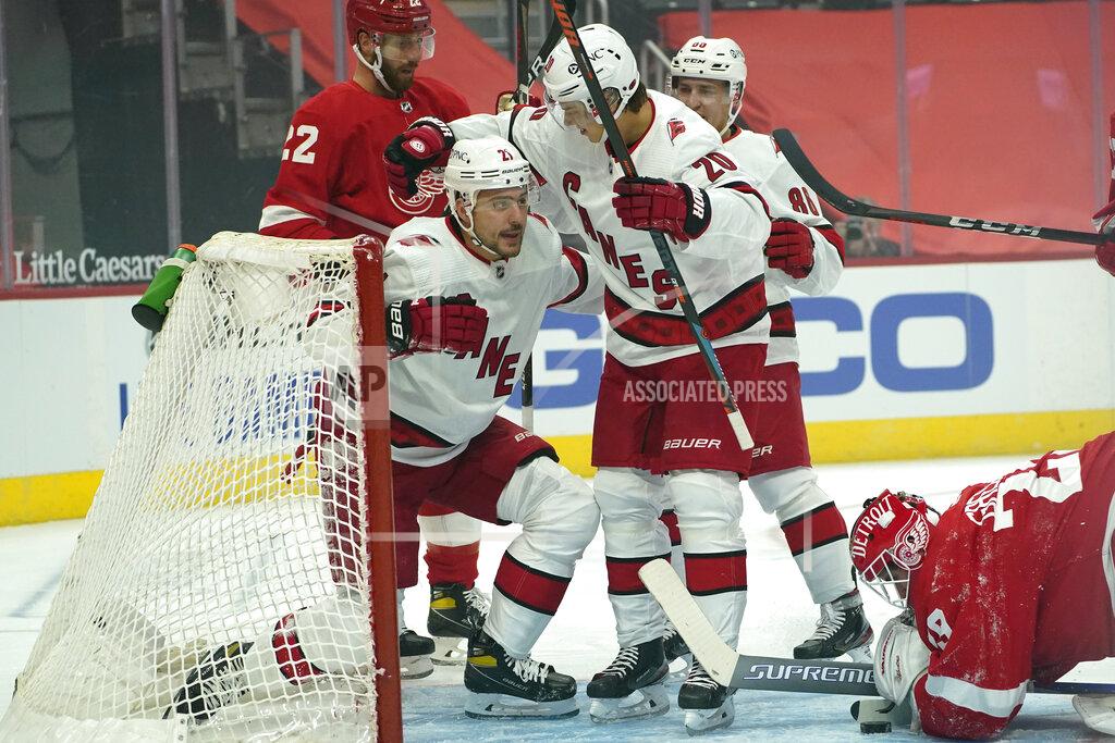 Paul Sancya Carolina Hurricanes right wing Nino Niederreiter (21) celebrates his goal with Sebastian Aho (20) as Detroit Red Wings goaltender Thomas Greiss (29) looks at the puck in the first period of an NHL hockey game Thursday, Jan. 14, 2021, in Detroit. (AP Photo/Paul Sancya)