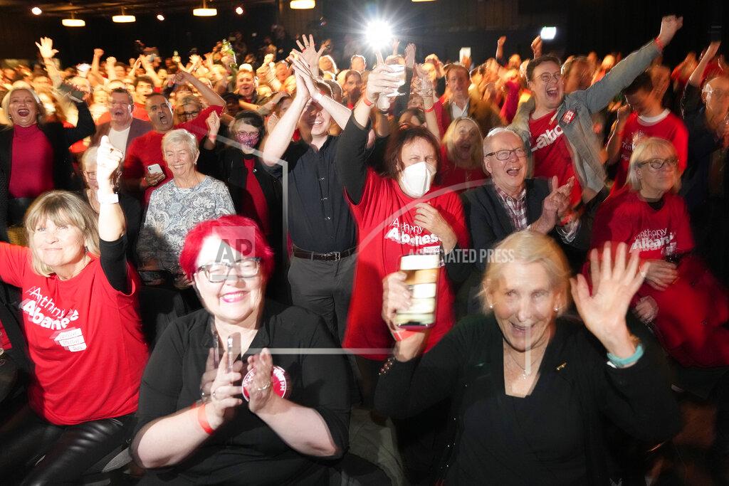 Rick Rycroft Supporters cheer at a Labor Party event following the close of the polling places in Sydney, Australia, Saturday, May 21, 2022. Australians voted following a six-week election campaign that has focused on pandemic-fueled inflation, climate change and fears of a Chinese military outpost being established less than 1,200 miles off Australia's shore. (AP Photo/Rick Rycroft)