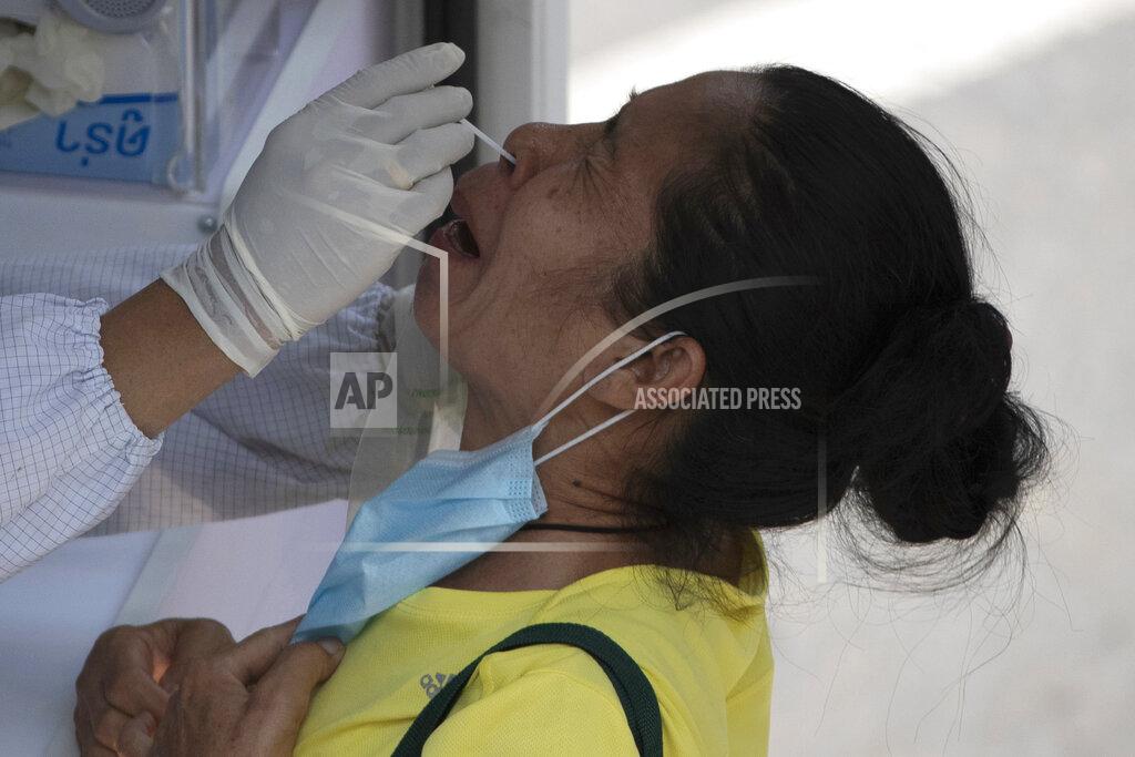 Sakchai Lalit A health worker collects a nasal swab from a woman for a coronavirus test in Bangkok, Thailand, Monday, March 15, 2021. Thai authorities set up mobile testing units for COVID-19 near a market where a new cluster of over a hundred cases was confirmed over the weekend. (AP Photo/Sakchai Lalit)