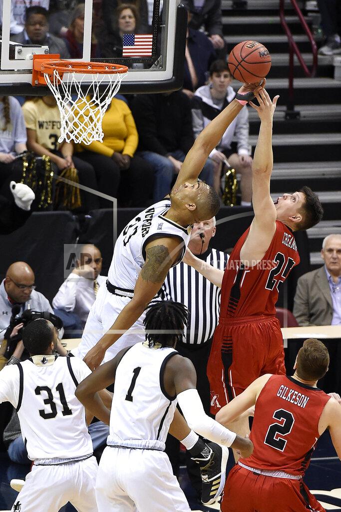 Kathy Kmonicek Wofford Terriers Cameron Jackson (33) stretches backwards to try to block a shot by VMI forward Tyler Creammer (25) in the first half of an NCAA college basketball game for the Southern Conference basketball tournament championship, Saturday, March 9, 2018, in Asheville, N.C. Wofford won 97-72. (AP Photo/Kathy Kmonicek)