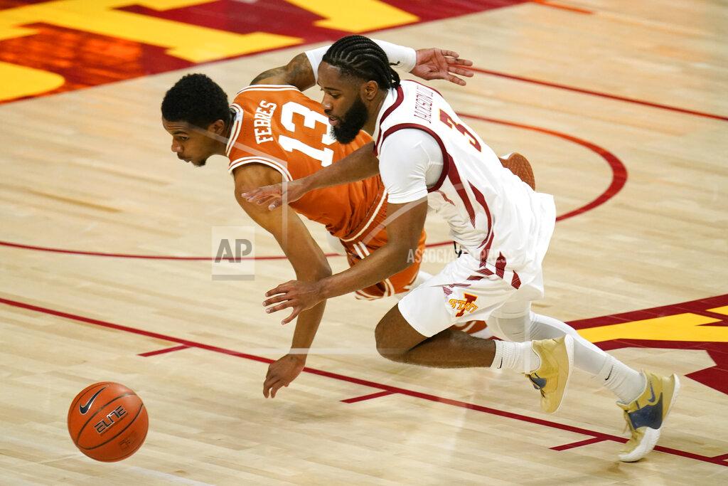 Charlie Neibergall Texas guard Jase Febres (13) fights for a loose ball with Iowa State guard Tre Jackson (3) during the first half of an NCAA college basketball game, Tuesday, March 2, 2021, in Ames, Iowa. (AP Photo/Charlie Neibergall)