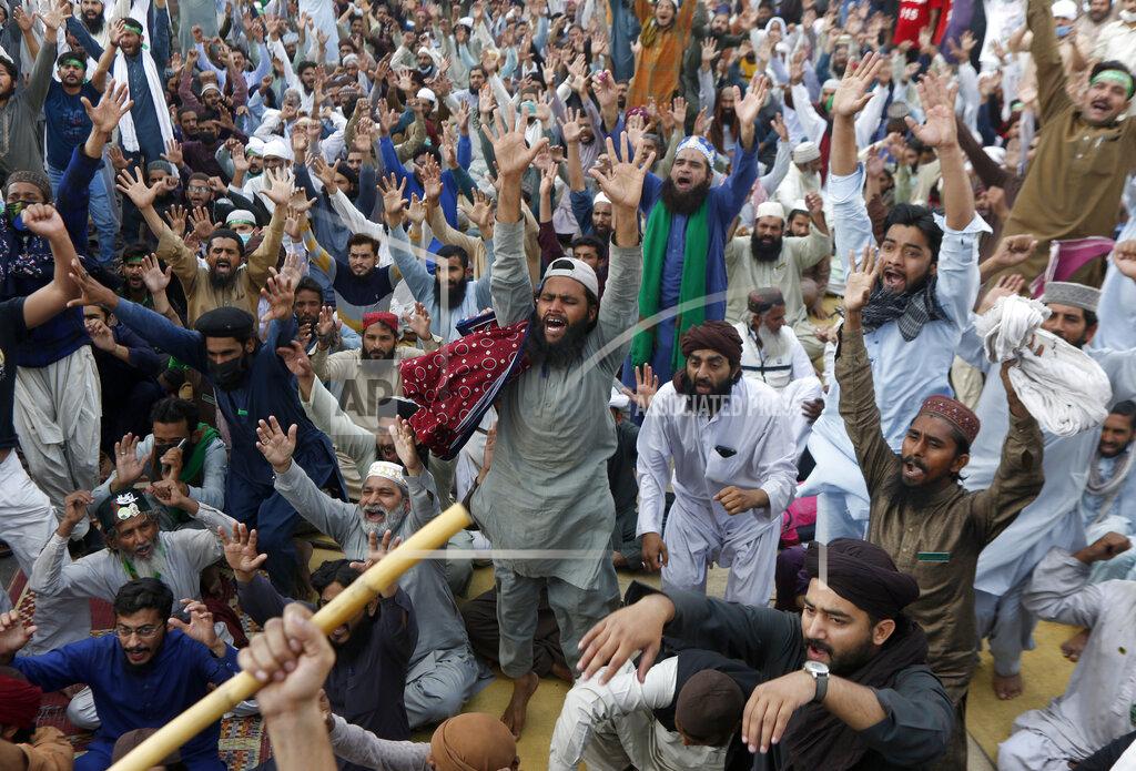 K.M. Chaudary Supporters of Tehreek-e-Labiak Pakistan, a banned Islamist party, chant slogans during a protest on the arrest of their party leader Saad Rizvi, who was demanding the government to expel French ambassador, in Lahore, Pakistan, Monday, April 19, 2021. The outlawed Pakistani Islamist political group freed 11 policemen almost a day after taking them hostage in the eastern city of Lahore amid violent clashes with security forces, the country's interior minister said Monday. (AP Photo/K.M. Chaudary)