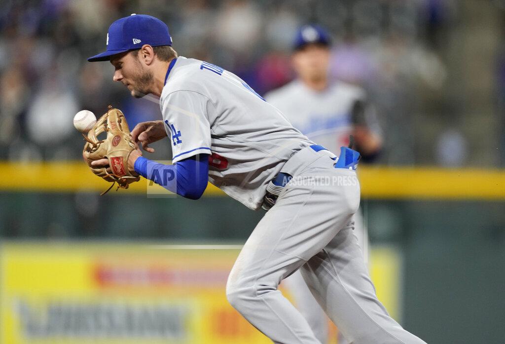 David Zalubowski Los Angeles Dodgers shortstop Trea Turner bobbles a ground ball that was ruled a single off the bat of Colorado Rockies' Garrett Hampson in the fourth inning of a baseball game Tuesday, Sept. 21, 2021, in Denver. (AP Photo/David Zalubowski)