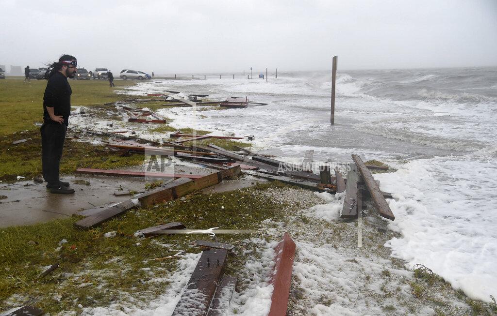 Annie Rice A man stands along the Bayfront during Hurricane Hanna, Saturday, July 25, 2020, in Corpus Christi, Texas. Water surged along the Coastal Bend. (Annie Rice/Corpus Christi Caller-Times via AP)