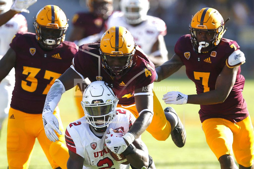 Rick Scuteri Utah defensive tackle Hauati Pututau (41) tackles Utah running back Zack Moss from behind in the second half during an NCAA college football game, Saturday, Nov. 3, 2018, in Tempe, Ariz. (AP Photo/Rick Scuteri)