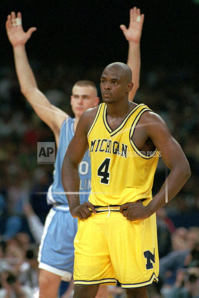 Susan Ragan FILE - In this April 5, 1993, file photo, Michigan's Chris Webber (4) stands by as North Carolina's Eric Montross celebrates during North Carolina's technical foul shots in the final seconds of the NCAA Final Four championship game at the Superdome in New Orleans. Webber called a time out Michigan did not have, and Michigan was charged with a technical foul and lost possession of the ball. Donald Williams made all four free throws and North Carolina won the national title 77-71. (AP Photo/Susan Ragan, File)