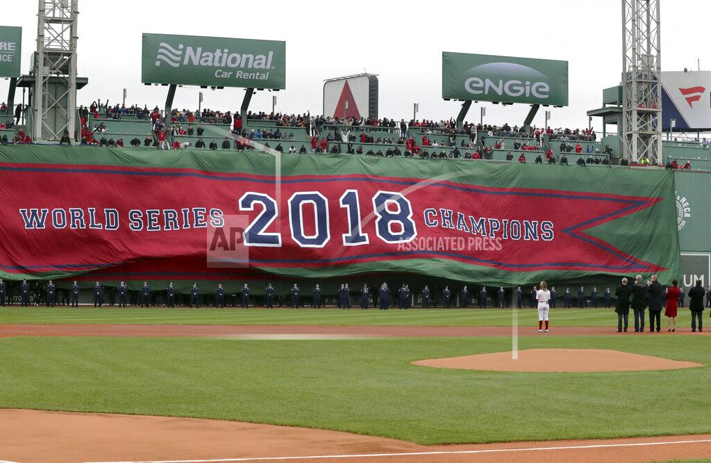 Charles Krupa The 2018 World Series Champions banner is unfurled on the Green Monster left field wall of Fenway Park before the home opener baseball game between the Red Sox and the Toronto Blue Jays, Tuesday, April 9, 2019, in Boston. (AP Photo/Charles Krupa)