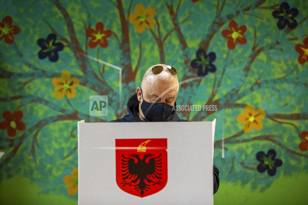 Visar Kryeziu An Albanian man casts his vote during parliamentary elections in capital Tirana, Albania, Sunday, April 25, 2021. Albanian voters have started casting ballots in parliamentary elections on Sunday amid the virus pandemic and a bitter political rivalry between the country's two largest political parties. (AP Photo/Visar Kryeziu)