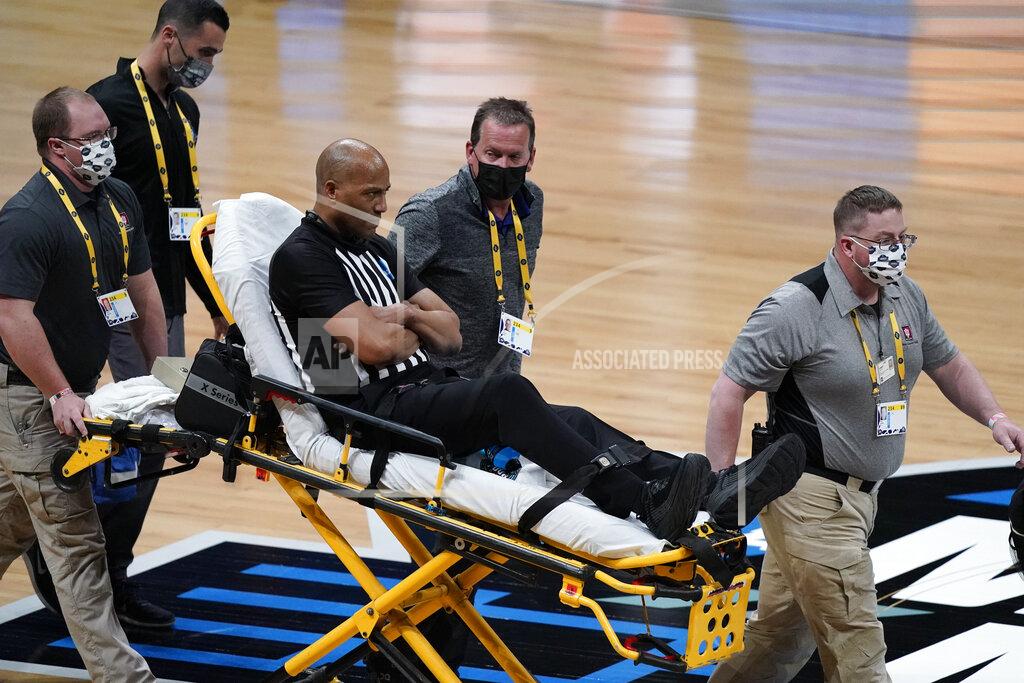 Michael Conroy Referee Bert Smith is taken off the court on a stretcher after collapsing during the first half of an Elite 8 game between Gonzaga and Southern California during the first half of an Elite 8 game in the NCAA men's college basketball tournament at Lucas Oil Stadium, Tuesday, March 30, 2021, in Indianapolis. (AP Photo/Michael Conroy)