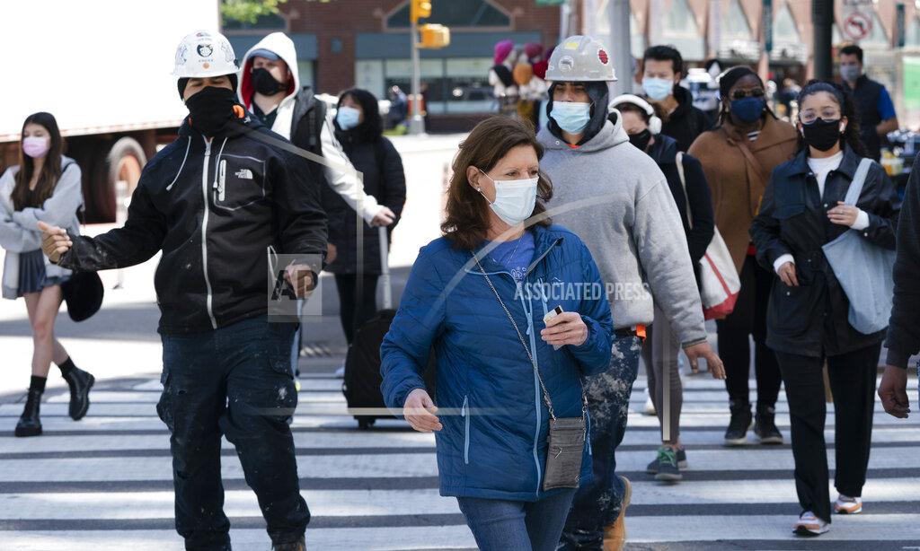 People walk on the street, Monday, April 26, 2021 in New York. The once-a-decade head count of the United States shows where the population grew during the past 10 years and where it shrank. New York will lose one seat in Congress as a result of national population shifts, according to census data released Monday. (AP Photo/Mark Lennihan)