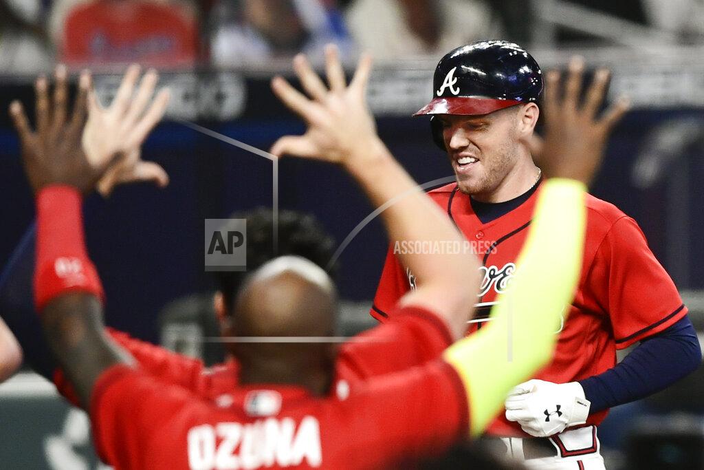 Atlanta Braves' Freddie Freeman crosses home plate to score on a winning two-run home during the 11th inning of a baseball game against the Boston Red Sox, Friday, Sept. 25, 2020, in Atlanta. (AP Photo/John Amis)