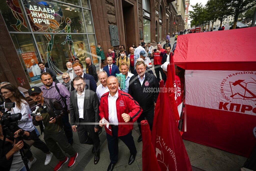 Alexander Zemlianichenko Russian Communist Party leader Gennady Zyuganov, center in red, and other party activists march along a street in Moscow, Russia, on Thursday, Aug. 26, 2021, during a campaign event ahead of the election for the State Duma, the lower house of parliament. Russia is holding three days of voting, ending on Sunday, Sept. 19, for a new parliament that is unlikely to change the country’s political complexion. The Carnegie Moscow Center's prognosis suggests that most of the seats lost by United Russia would be picked up by the Communist Party, the second-largest parliamentary faction. (AP Photo/Alexander Zemlianichenko)
