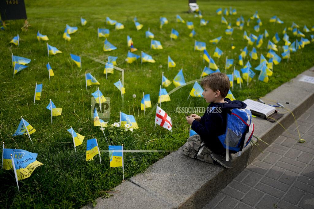 Natacha Pisarenko A boy watches flags honoring soldiers killed fighting Russian troops in downtown Kyiv, Ukraine, Monday, May 23, 2022. (AP Photo/Natacha Pisarenko)
