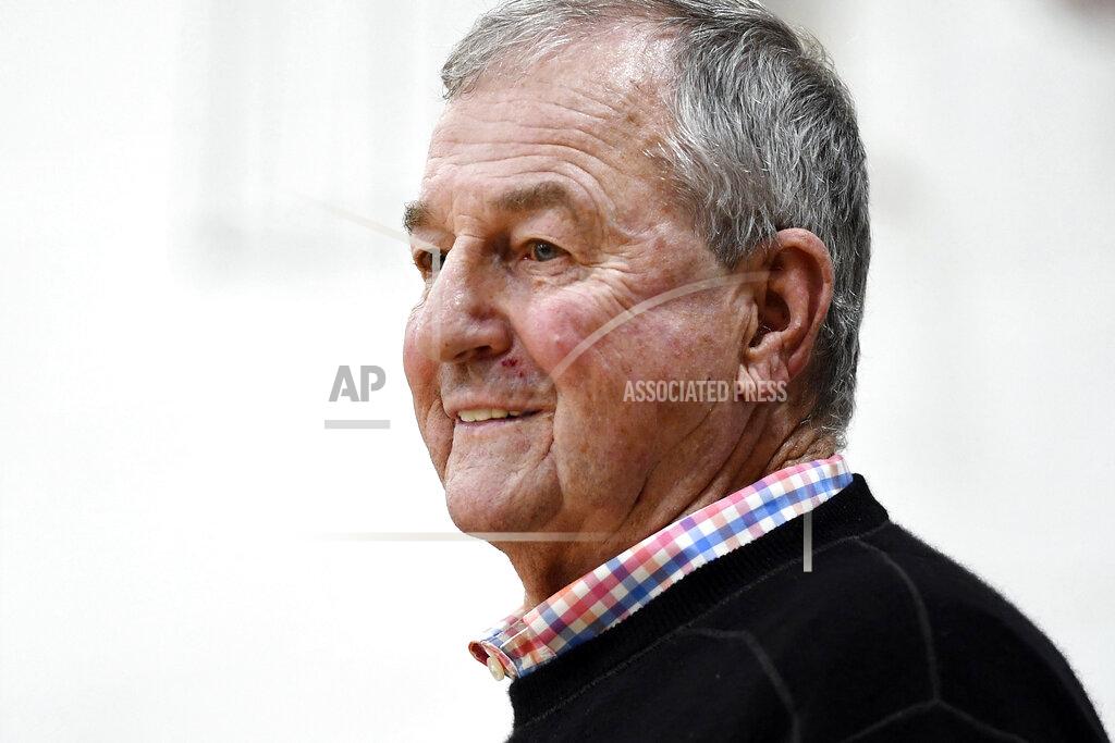 Jessica Hill Saint Joseph coach Jim Calhoun smiles during the first half of the team's NCAA college basketball game against Pratt Institute, Friday, Jan. 10, 2020, in West Hartford, Conn. Now coaching Division III basketball with the same fire he stalked the sidelines at UConn, Calhoun is reaching his 900th win as a college coach. (AP Photo/Jessica Hill)
