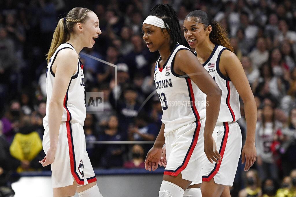 Jessica Hill Connecticut's Paige Bueckers, left, Christyn Williams, center, and Evina Westbrook react during the second half of a second-round women's college basketball game against Central Florida in the NCAA tournament, Monday, March 21, 2022, in Storrs, Conn. (AP Photo/Jessica Hill)